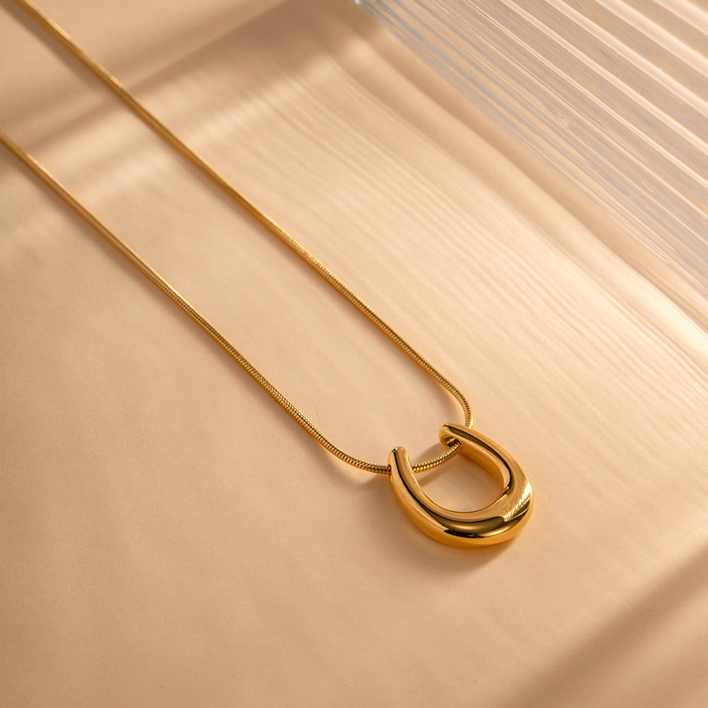 18K gold U-shaped geometric pendant necklace, clean architectural U-form pendant on chain, titanium steel with PVD gold plating, MINIMAL