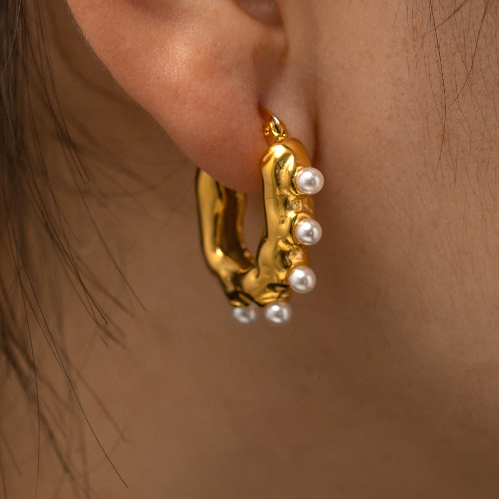 18K gold wave earrings on ear, pearl center organic detail — MINIMAL