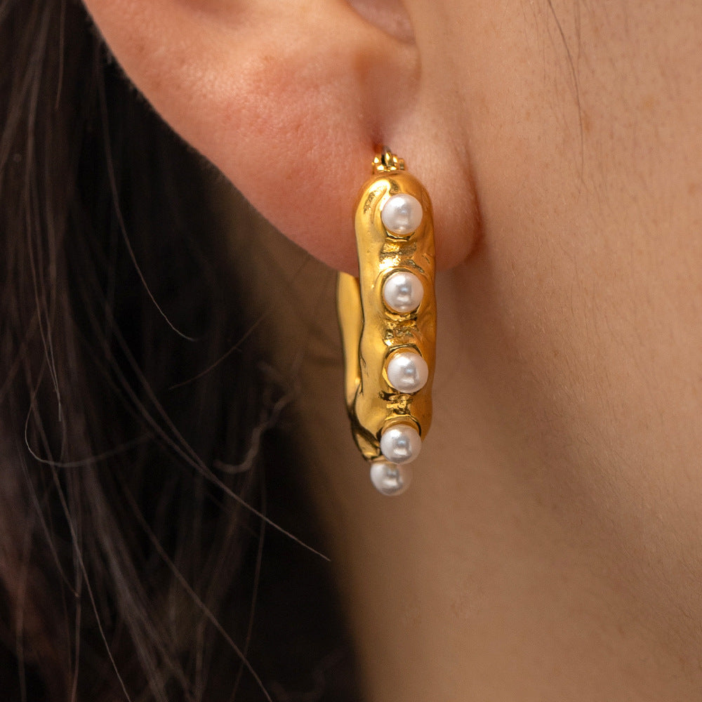 18K gold wave earrings on ear, pearl center organic detail — MINIMAL