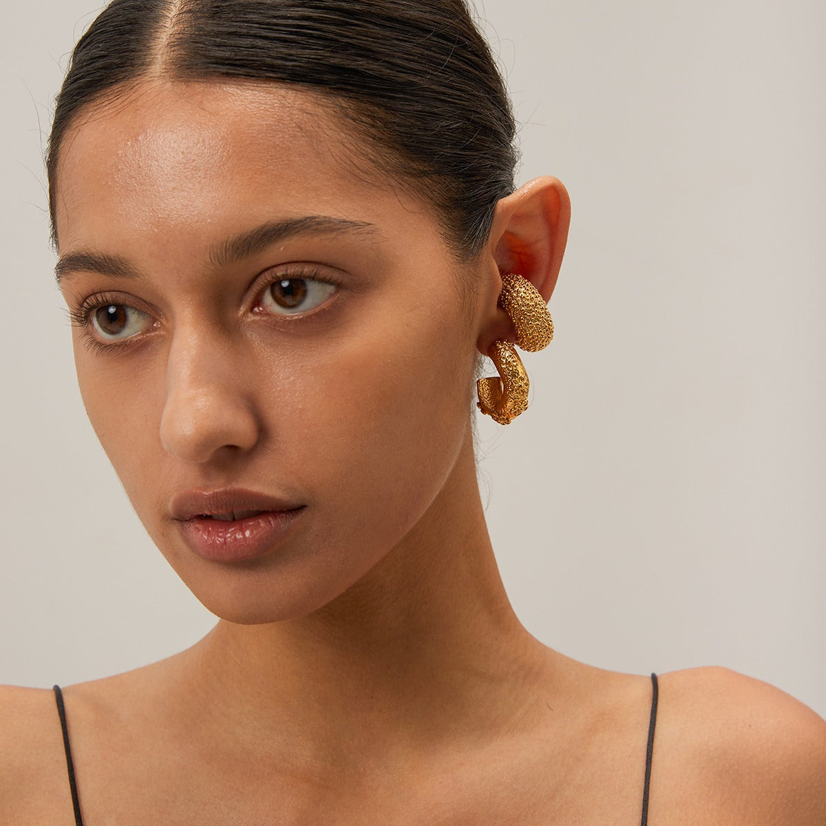 18K gold C-shape hammered flower earrings worn — lifestyle shot showing gold and silver finish options, MINIMAL Jeweler