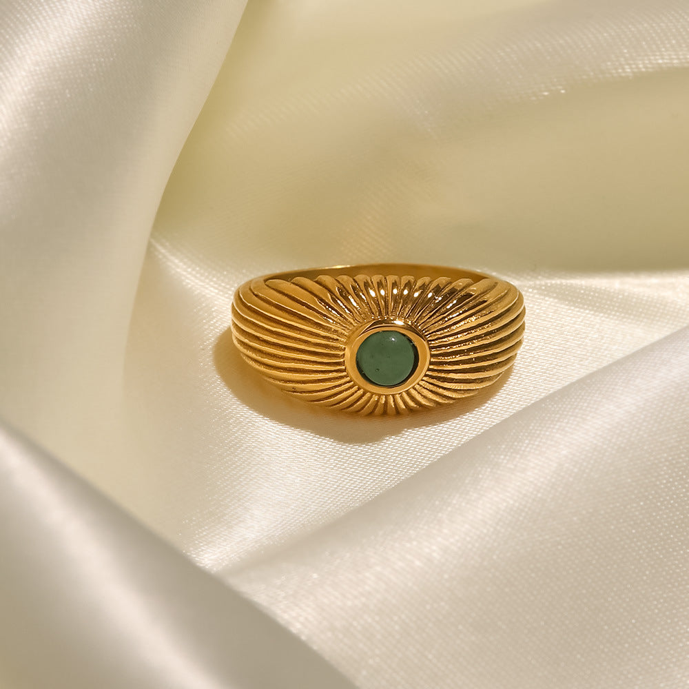 18K gold sun-shaped ring with natural green stone center, radiating silhouette, titanium steel with PVD gold plating, MINIMAL