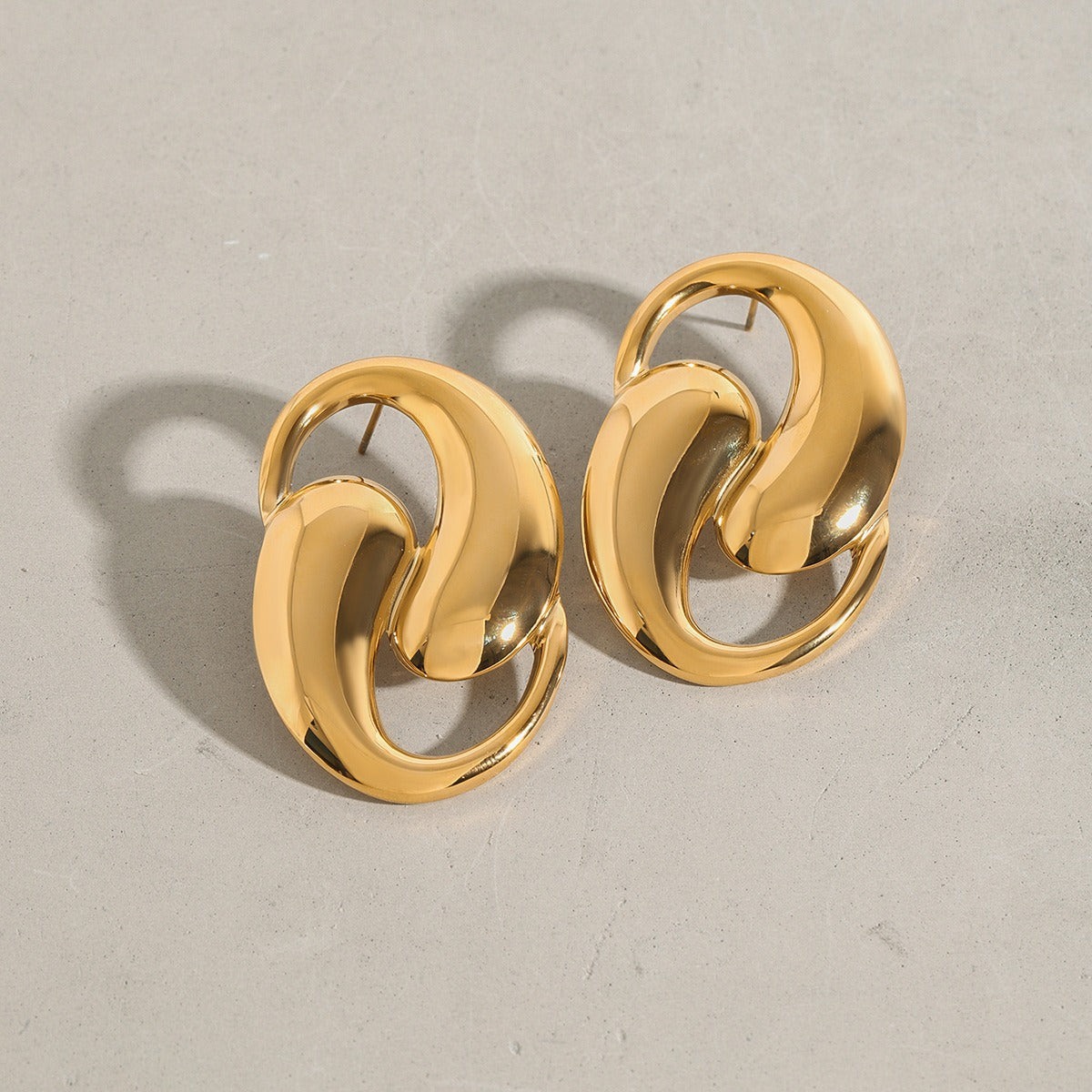 18K gold double teardrop hollow earrings in titanium steel — sculptural fine jewelry — MINIMAL