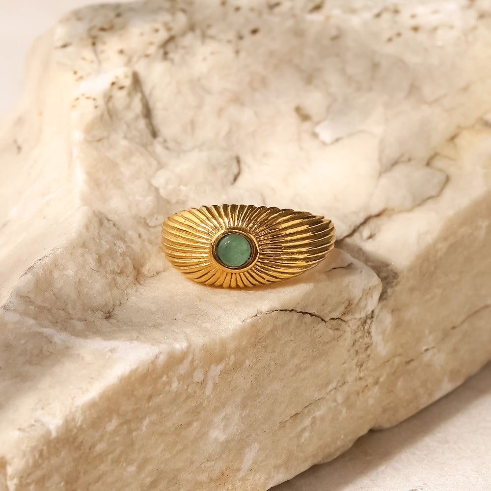 18K gold sun-shaped ring with natural green stone center, radiating silhouette, titanium steel with PVD gold plating, MINIMAL