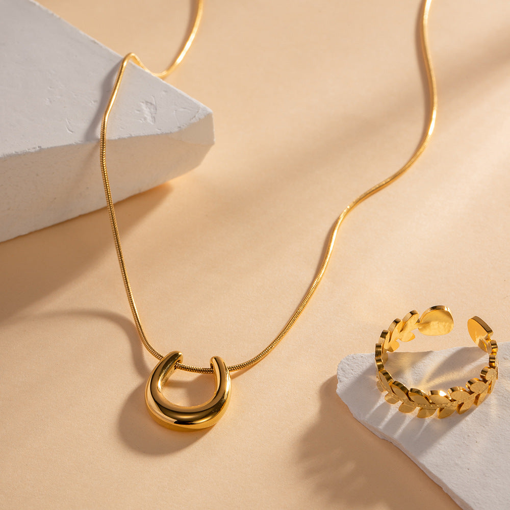 18K gold U-shaped geometric pendant necklace, clean architectural U-form pendant on chain, titanium steel with PVD gold plating, MINIMAL