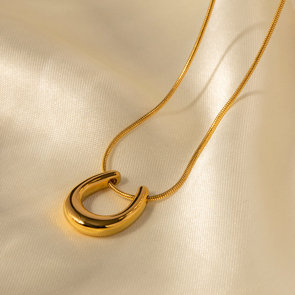 18K gold U-shaped geometric pendant necklace, clean architectural U-form pendant on chain, titanium steel with PVD gold plating, MINIMAL