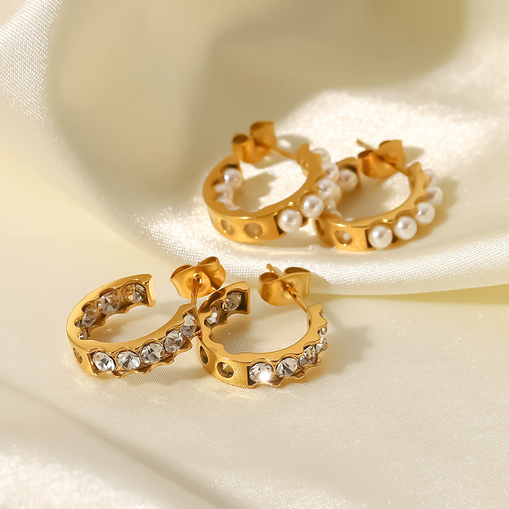 18K gold dangle earrings on ear, delicate drop detail — MINIMAL