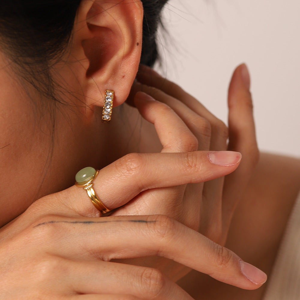 Close-up of 18K gold dangle earring, warm gold finish — MINIMAL