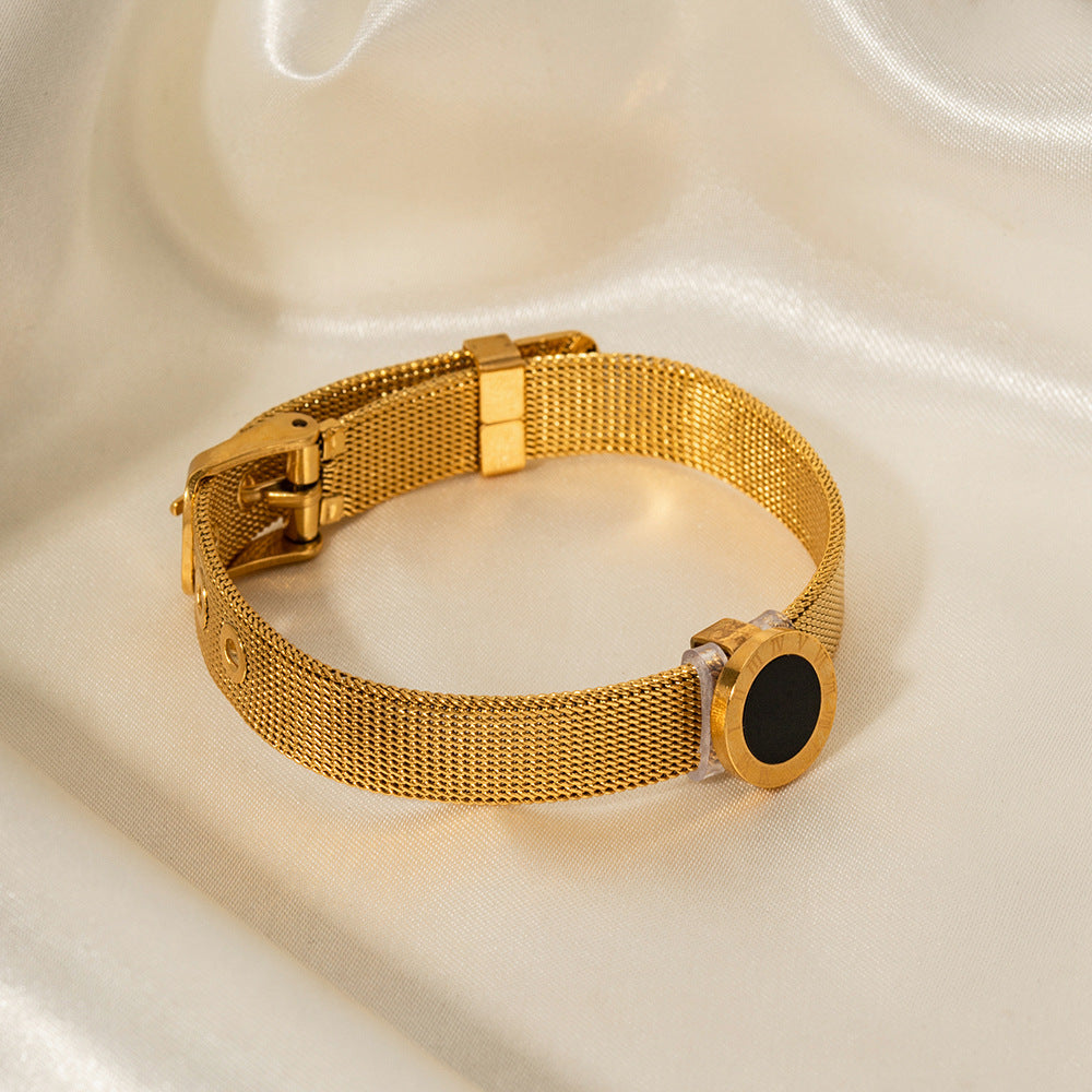 18K gold Roman numeral bracelet on wrist, black gemstone inlay detail — MINIMAL