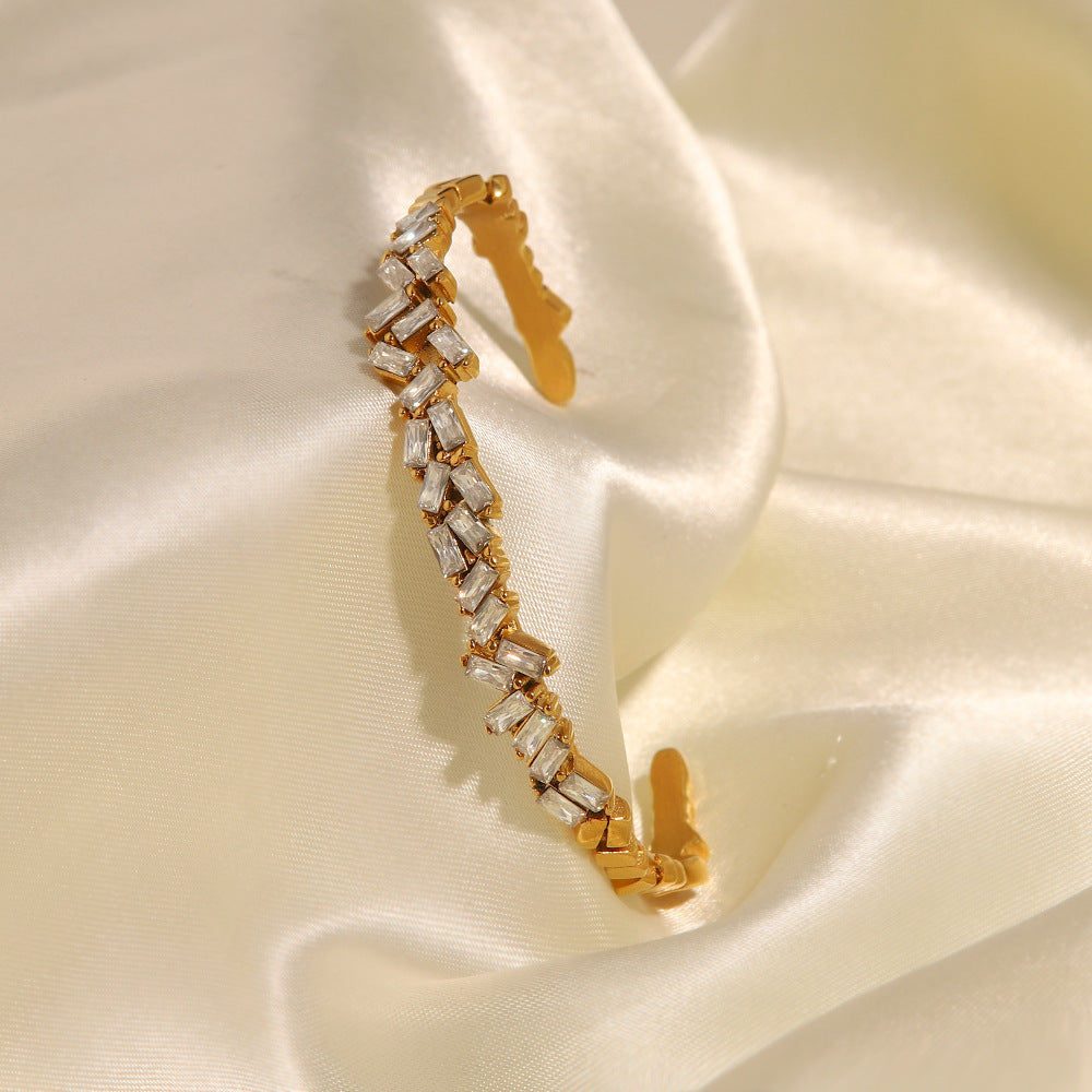 Close-up of zircon stone inlay on 18K gold open cuff bracelet — MINIMAL