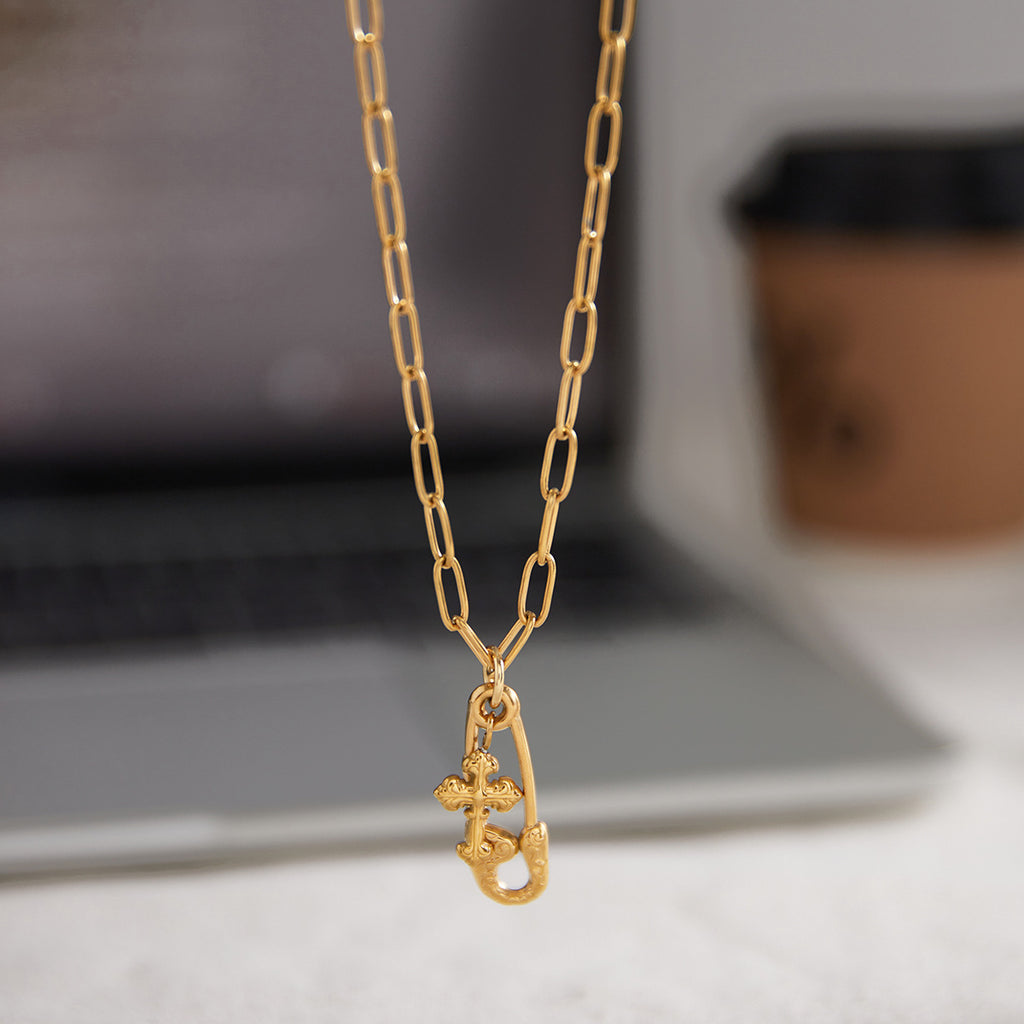 Alt text: Gold paperclip pendant necklace on link chain, polished stainless steel with gold-tone finish, MINIMAL