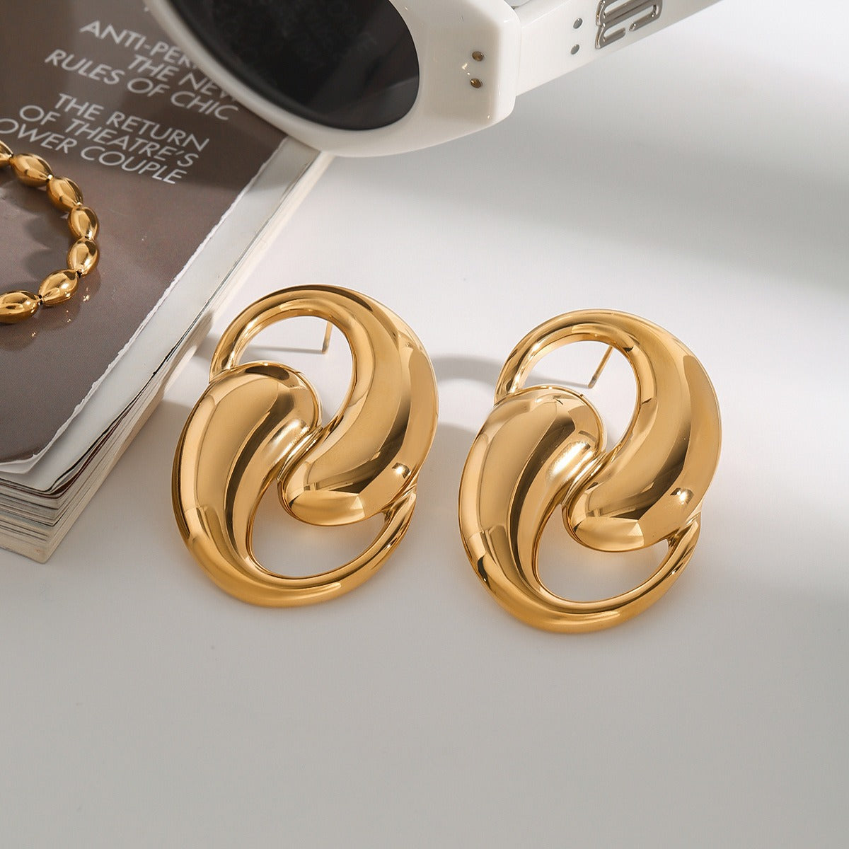 18K gold double teardrop hollow earrings in titanium steel — sculptural fine jewelry — MINIMAL