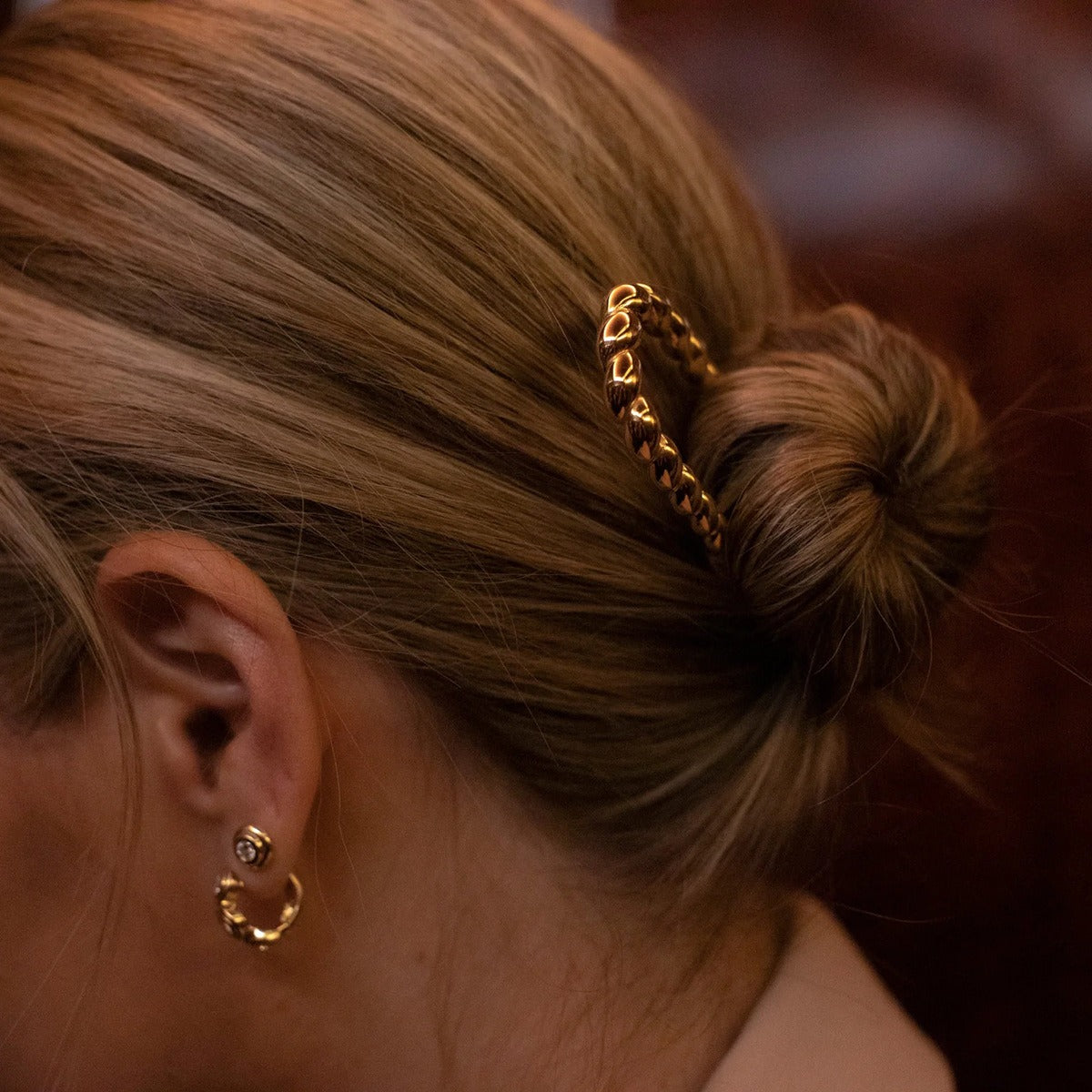 18K gold twisted hair accessory styled in updo, warm gold finish — MINIMAL