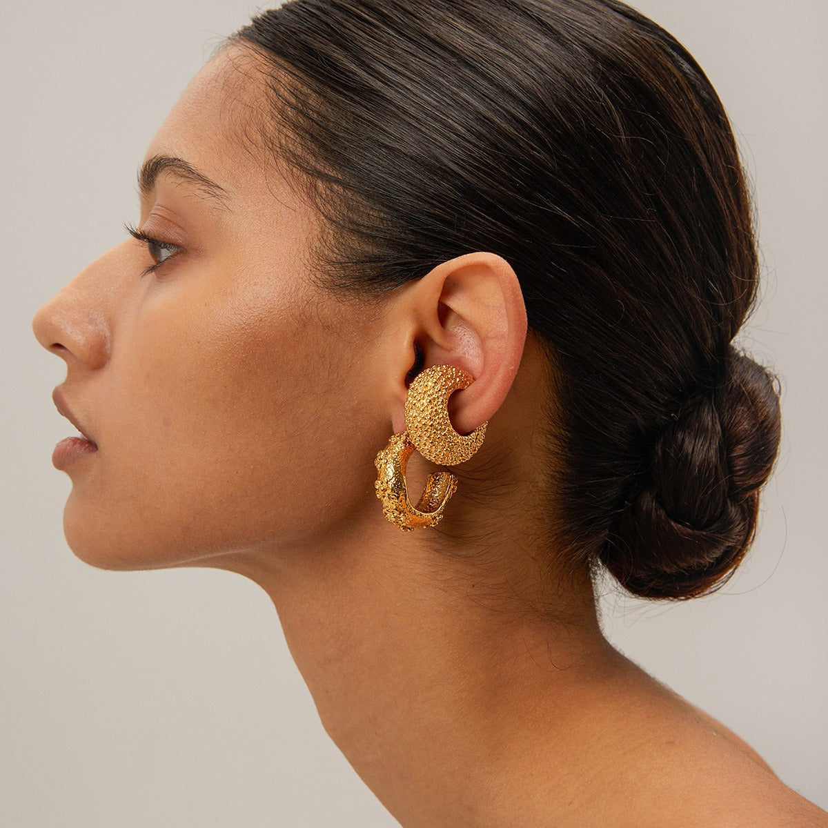 18K gold C-shape hammered flower earrings worn — lifestyle shot showing gold and silver finish options, MINIMAL Jeweler