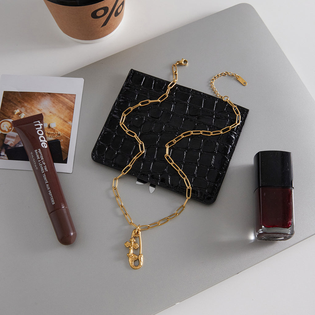 Alt text: Gold paperclip pendant necklace on link chain, polished stainless steel with gold-tone finish, MINIMAL