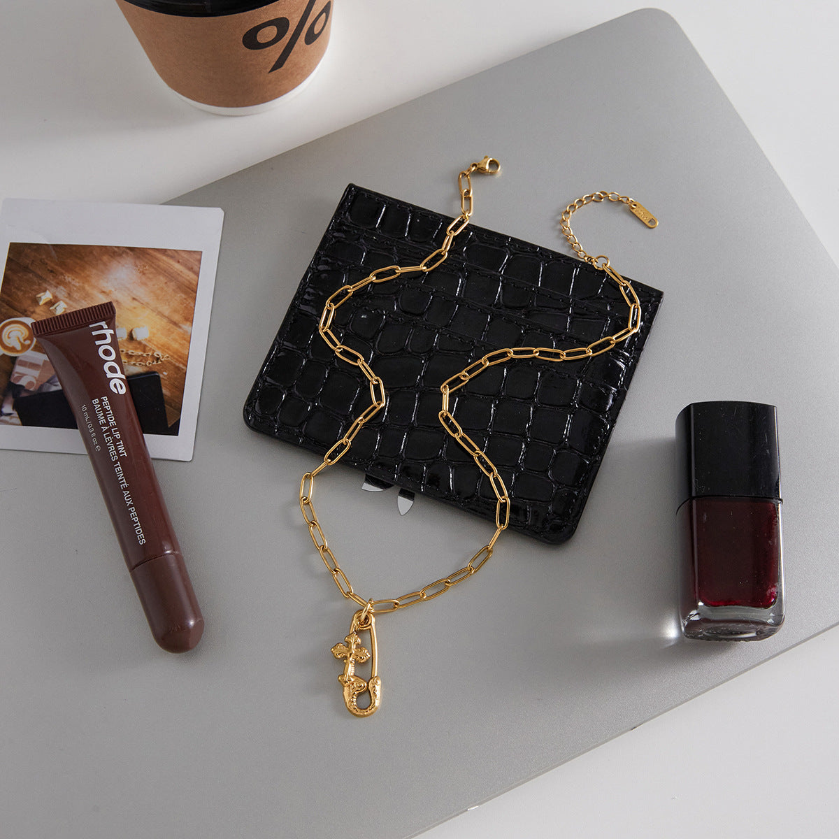 Alt text: Gold paperclip pendant necklace on link chain, polished stainless steel with gold-tone finish, MINIMAL