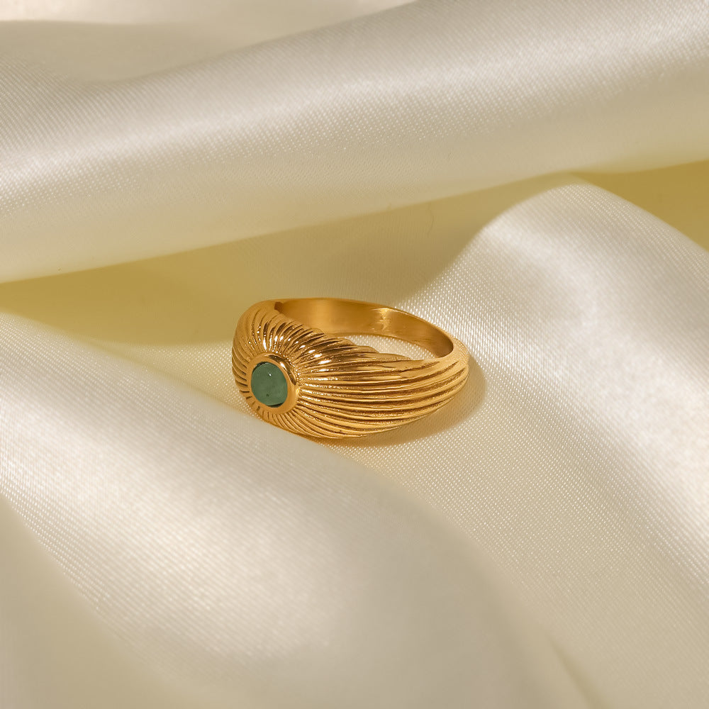 18K gold sun-shaped ring with natural green stone center, radiating silhouette, titanium steel with PVD gold plating, MINIMAL